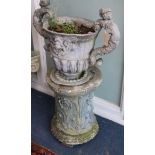 A lead two-handled urn on a composition pedestal W.57cm