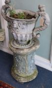 A lead two-handled urn on a composition pedestal W.57cm