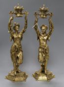 A pair of cast brass chinoiserie candlesticks with swivel sconces, height 41cm