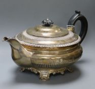 A George IV silver melon-shaped teapot, half-fluted and having ebonised handle and finial, gadrooned