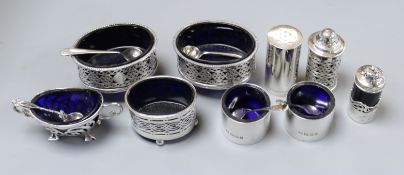 Two three piece silver condiment sets and three other silver condiments.