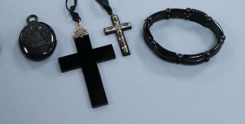 A jet style locket, a tortoiseshell and pique cross pendant and three other items.