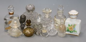 A silver-mounted cut glass toilet bottle and a group of glass perfume bottles, including a Dali '