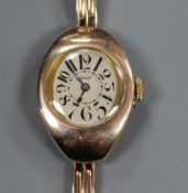 A lady's early 20th century 9ct gold oval cased manual wind wrist watch, retailed by Asprey, on