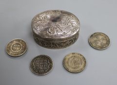 An Indian white metal box and various coins