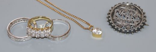A yellow metal heart-shaped cubic zirconia pendant on a 9ct gold chain, three 925/925-gilt rings and