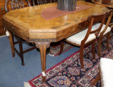 A 1930's figured walnut octagonal topped extending dining table, extends to 182 x 97cm