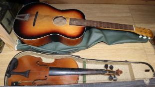 A cased violin, bow and a guitar