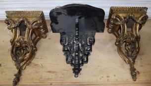 A pair of gilt wood wall brackets, carved with acanthus leaves and laurel swags and an ebonised