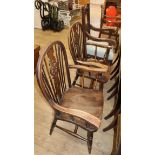 A carved oak framed armchair and a pair of elm and beech wheel back elbow chairs (3)