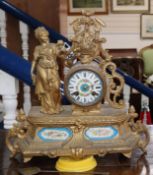 A Louis XV style gilt metal cased 8 day mantel clock, with Sevres style porcelain mounts