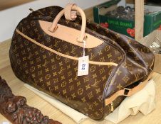 A Louis Vuitton Eole 50 monogram canvas rolling bag, having gold-toned hardware, tan leather trim,