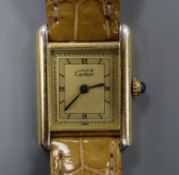 A lady's Must de Cartier 925 Vermeil Tank quartz wrist watch, on Cartier strap, with Cartier box.