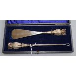 A cased Edwardian silver mounted 'owl' buttonhook and shoehorn, Crisford & Norris, Birmingham,