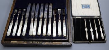 A cased set of twelve pairs of George V mother of pearl handled silver fruit eaters and four