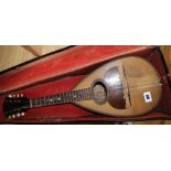 An early 20th century cased mandolin 61cm long