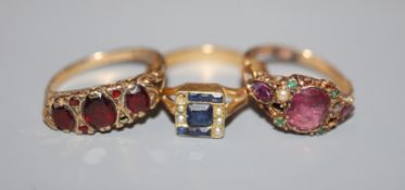 Three assorted gem set rings, 18ct, 15ct and 9ct, the 15ct ring in the 'suffragette' colours(a.f.).