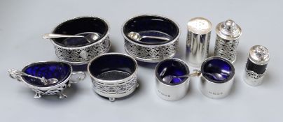 Two silver condiment sets (4 piece and 3 piece) and three other silver condiments.