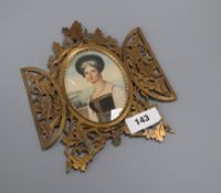 An ormolu framed printed portrait miniature of a Greek woman, brass frame