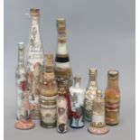 A group of Isle of Wight and other sand picture bottles tallest 37cm