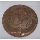 A carved African shield 51cm diameter
