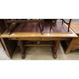 A Continental oak 1920's extending dining table W.136cm