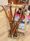 A group of walking sticks and canes, including a sword stick c.1900 and a Chinese silver topped