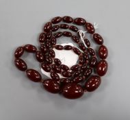 A single strand graduated simulated cherry amber necklace, gross weight 63 grams, 82cm.