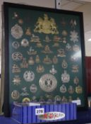 A large collection of military caps and tunic badges (some framed)