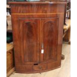 A Regency mahogany bow fronted hanging corner cupboard W.87cm