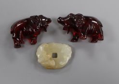 A Chinese pale celadon jade 'bat' bi disc and two cherry amber elephants