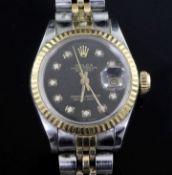 A lady's steel and gold Rolex Oyster Perpetual Datejust wrist watch, with black dial and diamond dot