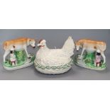 A pair of Staffordshire pottery cow and milk maid groups and a hen dish and cover Staffordshire