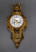 A French ormolu cartel clock, 19th century, having white enamelled Roman dial with blue numerals