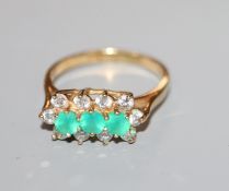 A 9ct gold, diamond and emerald line cluster ring, size Q.