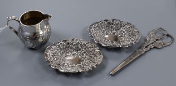 A late Victorian silver cream jug, a pair of silver bon bon dishes and a pair of silver scissors.