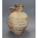 An antique Cypriot pottery jar, circa 700 BC, having banded decoration of varying width and fitted