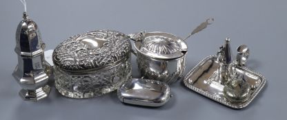 An Edwardian silver chamberstick, a silver caster, a silver mustard pot and three other items