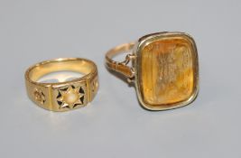 A Victorian yellow metal and enamel ring and a Victorian yellow metal and citrine intaglio ring