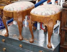 A pair of oval walnut stools W.56cm