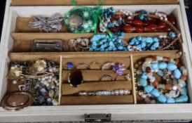 A jewellery box containing assorted costume jewellery.