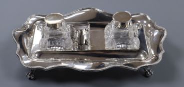 A George V silver two bottled inkstand and a late Victorian silver stamp box (a.f).
