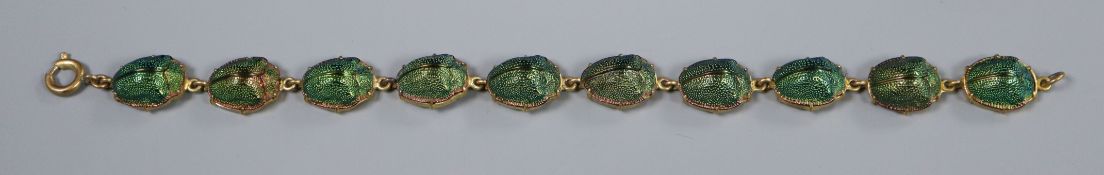 A gilt metal and scarab beetle set bracelet, 19.5cm.