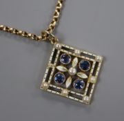 An early 20th century yellow metal, sapphire, enamel and seed pearl pendant, on a yellow metal