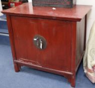 A Chinese red lacquered two door cabinet W.103cm