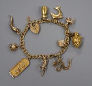 A 9ct gold curb-link bracelet with padlock clasp set with ten charms, four marked 9ct.