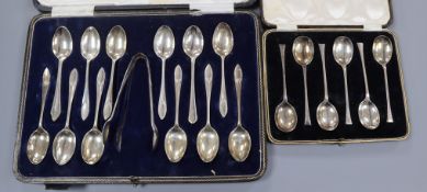 A George V cased set of twelve silver teaspoons and pair of sugar tongs and a cased set of six