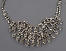 An ornate white metal and paste set three row fringe necklace, approx. 44cm.