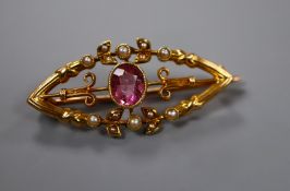 A late Victorian 15ct, pink tourmaline and seed pearl set elliptical brooch, 34mm.
