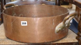 A Victorian copper two handled pan and a gong with beater